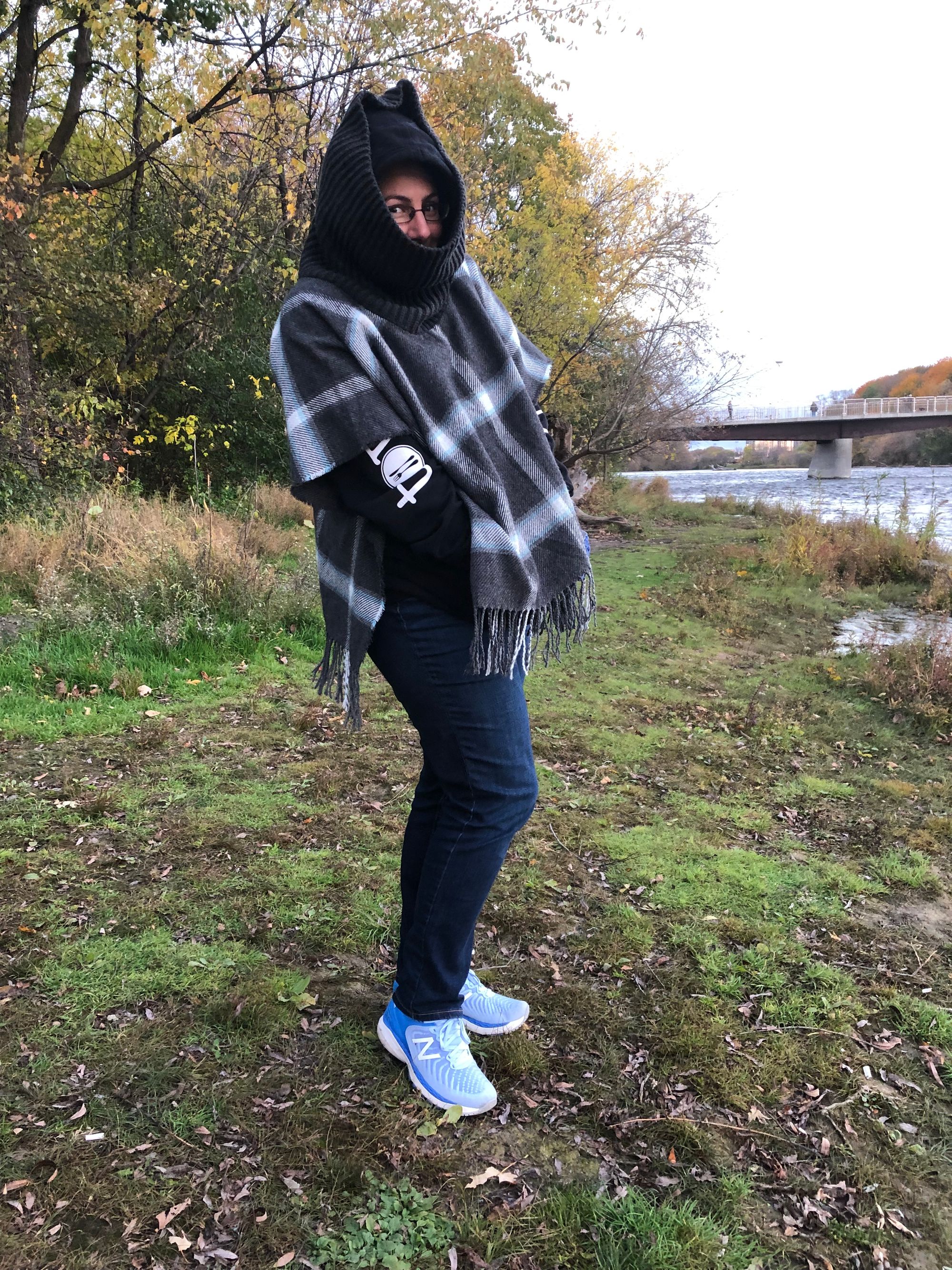 a photo of me wearing jeans, running shoes, and a chunky hoody with the hood pulled up over my head, on top of which is a poncho-like woolly scarf garment with a giant ribbed turtleneck obscuring most of my face. It is inelegant and hilarious.