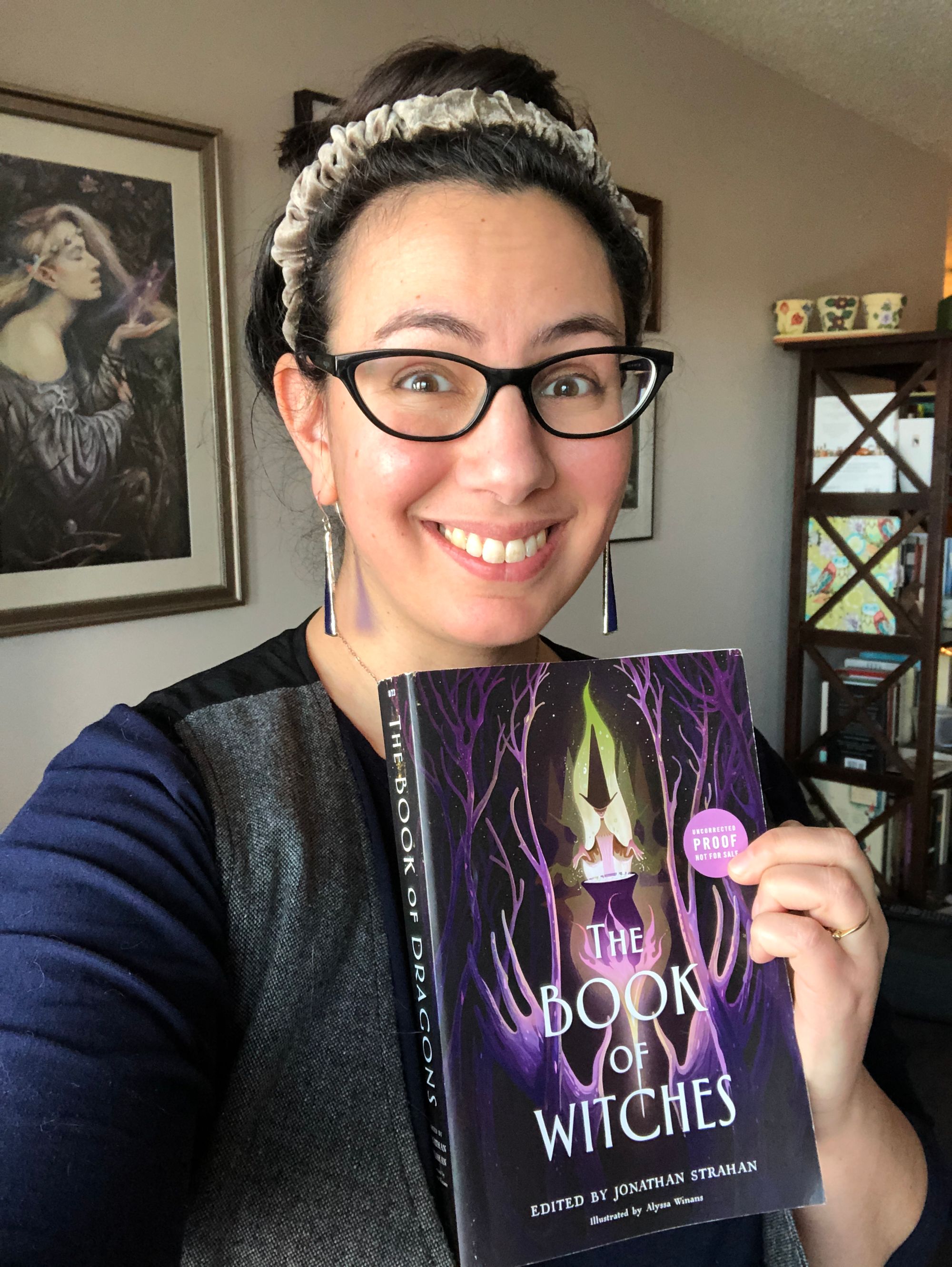 Selfie in which I'm holding up my advanced reading copy of THE BOOK OF WITCHES while grinning widely. 