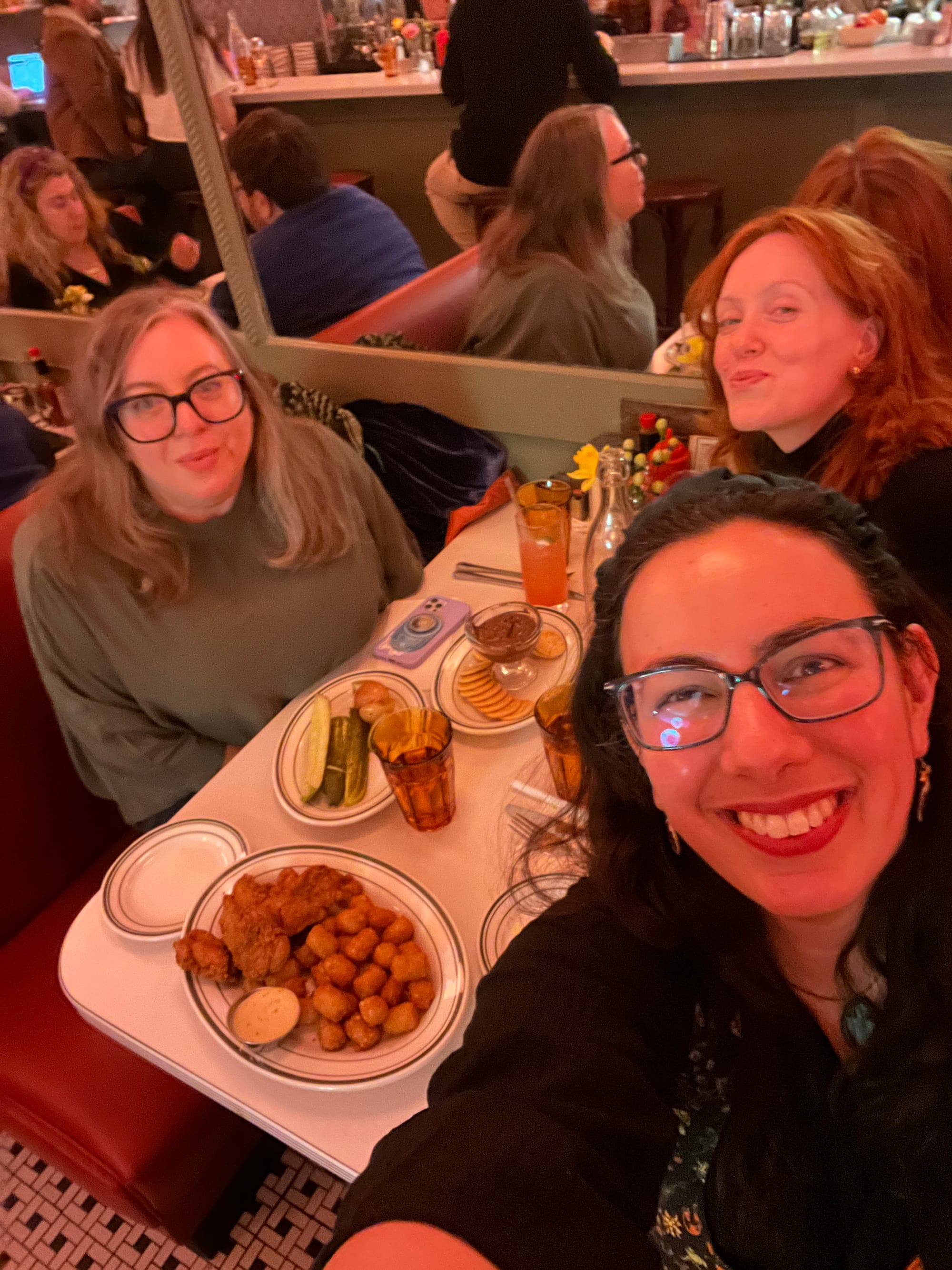 Diner table selfie in which I'm grinning excitedly at the camera and trying to angle it to capture Helen Rosner, Helena Fitzgerald, and a table of delicious food (chicken tenders and tater tots, pickles, and a bafflingly perfect plate of ritz crackers surrounding a goblet of nutella.)