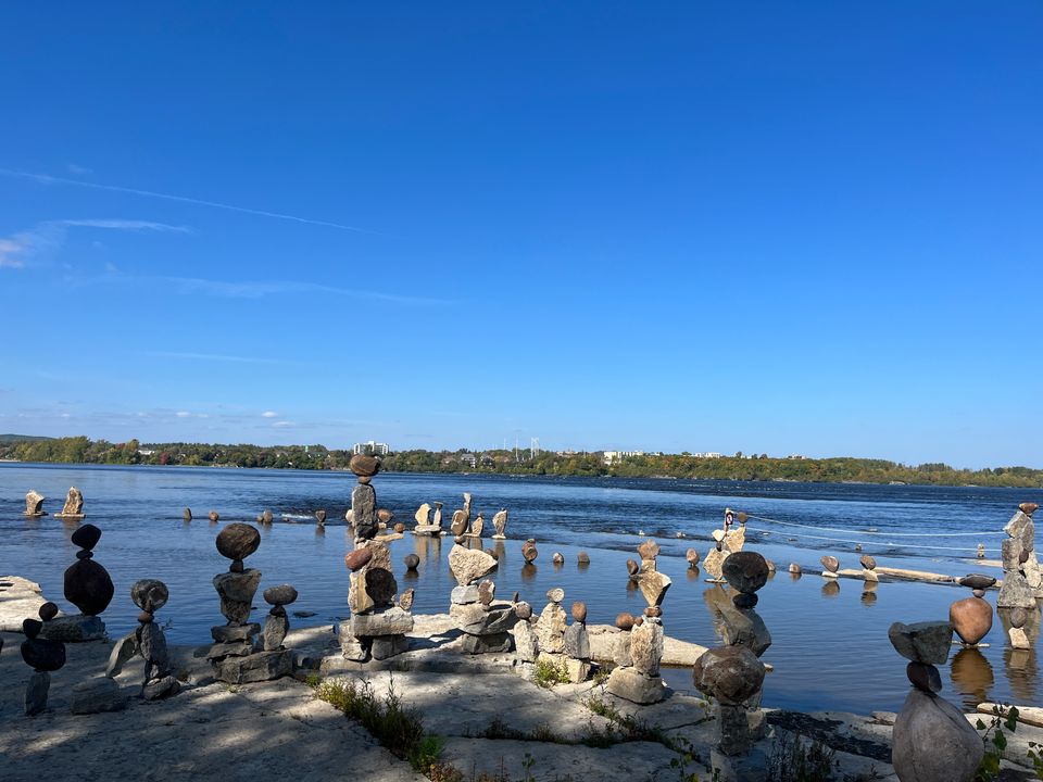 A view of the Ottawa river from Remic Rapids, with its famous free-standing stacked stone sculptures in the foreground.